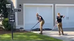 Two officers from the Charleston, SC, Police Department's Animal Control Unit wrangled an alligator that wandered close to a school Monday.