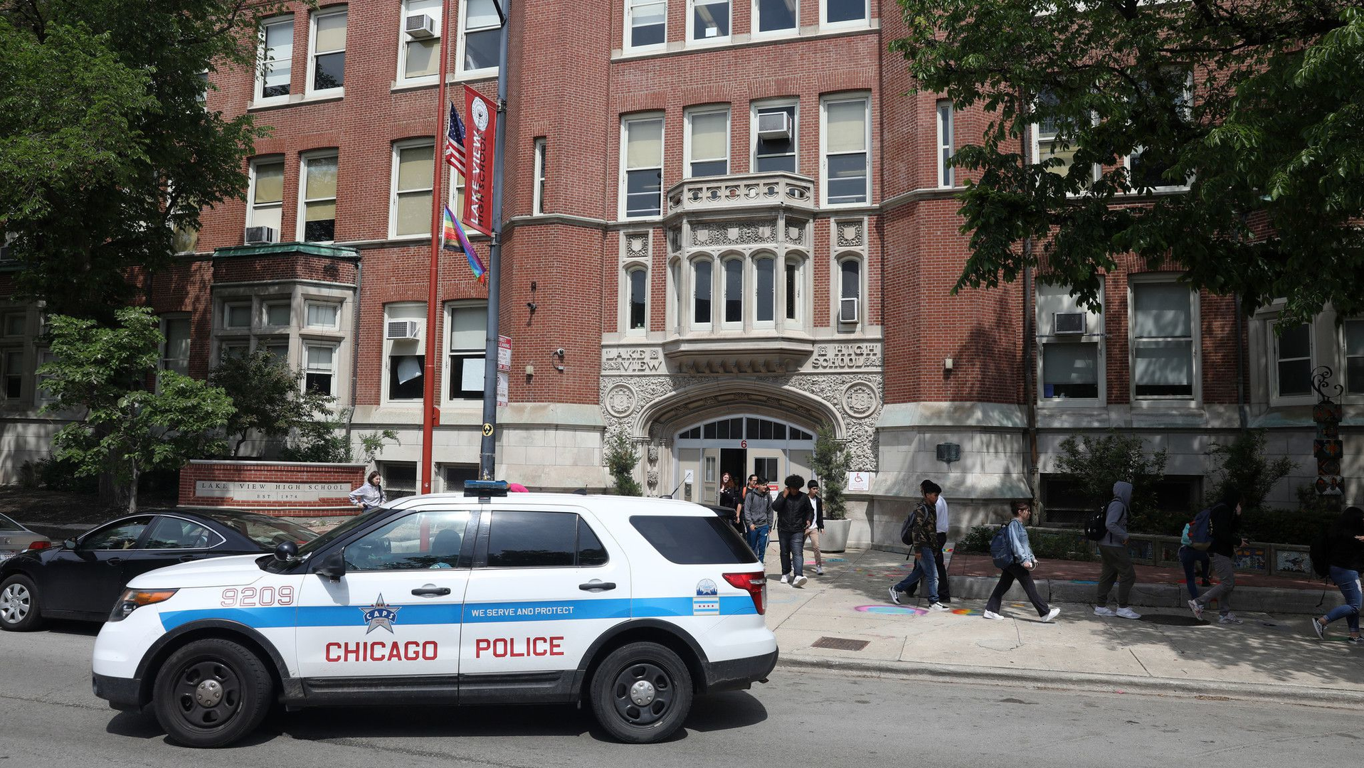 Chicago police monitor activity outside of Lake View High School in 2019. Lake View was among the campuses whose Local School Council voted in 2021 to remove school resource officers.