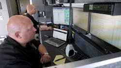 Dispatchers Dan Dobleman, front, and Sean Kelly staff the communications center in the Gloucester County, NJ, Office of Emergency Management mobile command center during the Gloucester County Child Abduction Response Team drill at Malaga Lake Park on April 26. Dispatchers Dan Dobleman, front, and Sean Kelly staff the communications center in the Gloucester County, NJ, Office of Emergency Management mobile command center during the Gloucester County Child Abduction Response Team drill at Malaga Lake Park on April 26.