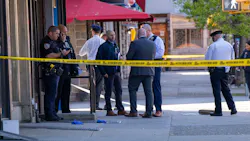 NYPD officers investigate outside department employee Migdalia Ortega's apartment building after she was fatally shot Monday. NYPD officers investigate outside department employee Migdalia Ortega's apartment building after she was fatally shot Monday.
