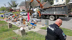 Newport News, VA, Master Police Officer Donald Greathouse with Department of Public Works employees to clear an illegal dumping site on 22nd Street in April. Greathouse has been piloting the Newport News environmental officer program since July. Newport News, VA, Master Police Officer Donald Greathouse with Department of Public Works employees to clear an illegal dumping site on 22nd Street in April. Greathouse has been piloting the Newport News environmental officer program since July.