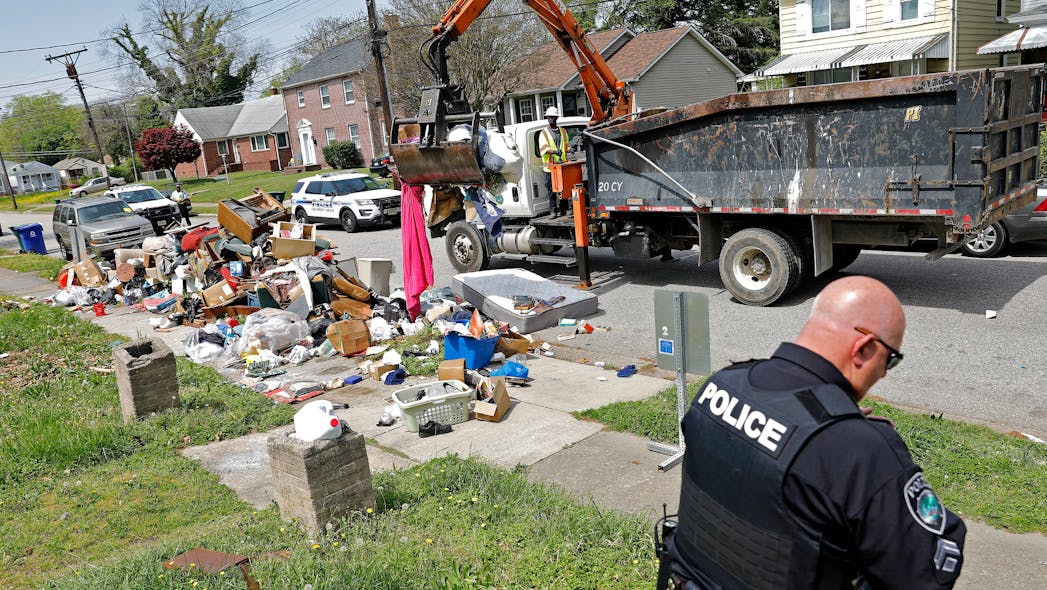 Newport News, VA, Master Police Officer Donald Greathouse with Department of Public Works employees to clear an illegal dumping site on 22nd Street in April. Greathouse has been piloting the Newport News environmental officer program since July.