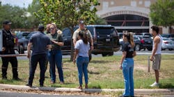 A law enforcement officer tells people Tuesday that Uvalde, TX, High School is secure after a school shooting at the nearby Robb Elementary School. A law enforcement officer tells people Tuesday that Uvalde, TX, High School is secure after a school shooting at the nearby Robb Elementary School.