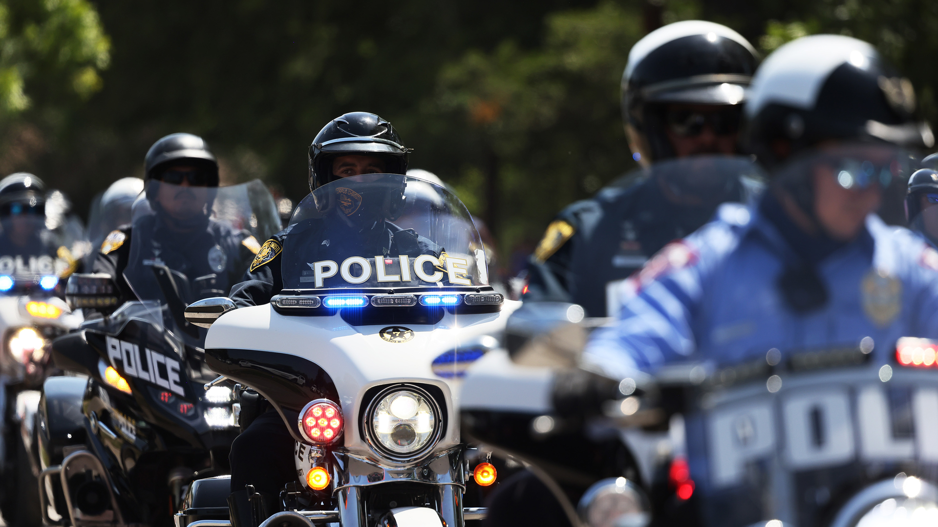 Law enforcement officials prepare for the arrival of President Joe Biden for mass at Sacred Heart Catholic Church on Sunday in Uvalde, TX.