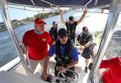 Capt. Art Serig (left) with Tactical Advantage Consultants instructs Wilton Manors, FL, Assistant Police Chief Darren Brodsky (center) in maneuvering a boat last week, along with Hollywood Police officers Alex Ramirez, Will LaPierre, and Alfred Stabile.