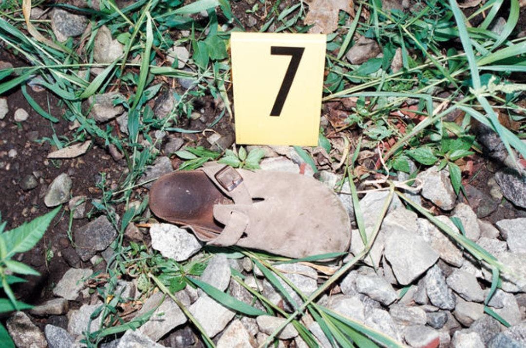 One of Holly Dunn&apos;s sandals lays in the ditch near the railroad tracks where Resendiz brutally attacked her and Chris Maier.