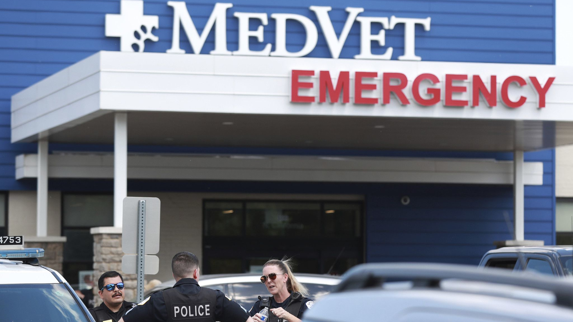 Chicago police officers stand outside MedVet veterinarian hospital in the city's Avondale neighborhood Thursday after reports of a U.S. deputy marshal and a K-9 being shot.
