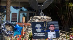 People continue to drop by El Monte, CA, Police Department headquarters and look at flowers, flags and balloons left outside in memory of the two officers slain earlier this month. People continue to drop by El Monte, CA, Police Department headquarters and look at flowers, flags and balloons left outside in memory of the two officers slain earlier this month.