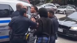 An NYPD officer was spat on and punched by a man and woman while police tried to take another woman into custody over loud music playing from a stereo in East Harlem on Tuesday. An NYPD officer was spat on and punched by a man and woman while police tried to take another woman into custody over loud music playing from a stereo in East Harlem on Tuesday.