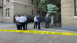 Detectives investigate outside a home in the Bronx where authorities say an off-duty NYPD officer was stabbed and killed by her husband early Monday.