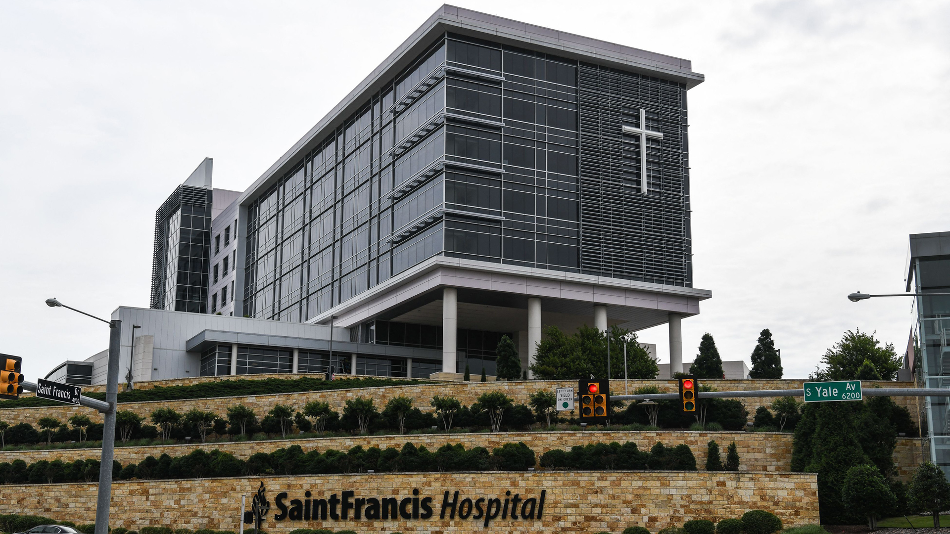 Cars drive past the Saint Francis Hospital campus in Tulsa, Okla., on Thursday less than a day after a gunman killed at least four people in a medical building there.