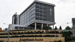 Cars drive past the Saint Francis Hospital campus in Tulsa, Okla., on Thursday less than a day after a gunman killed at least four people in a medical building there.