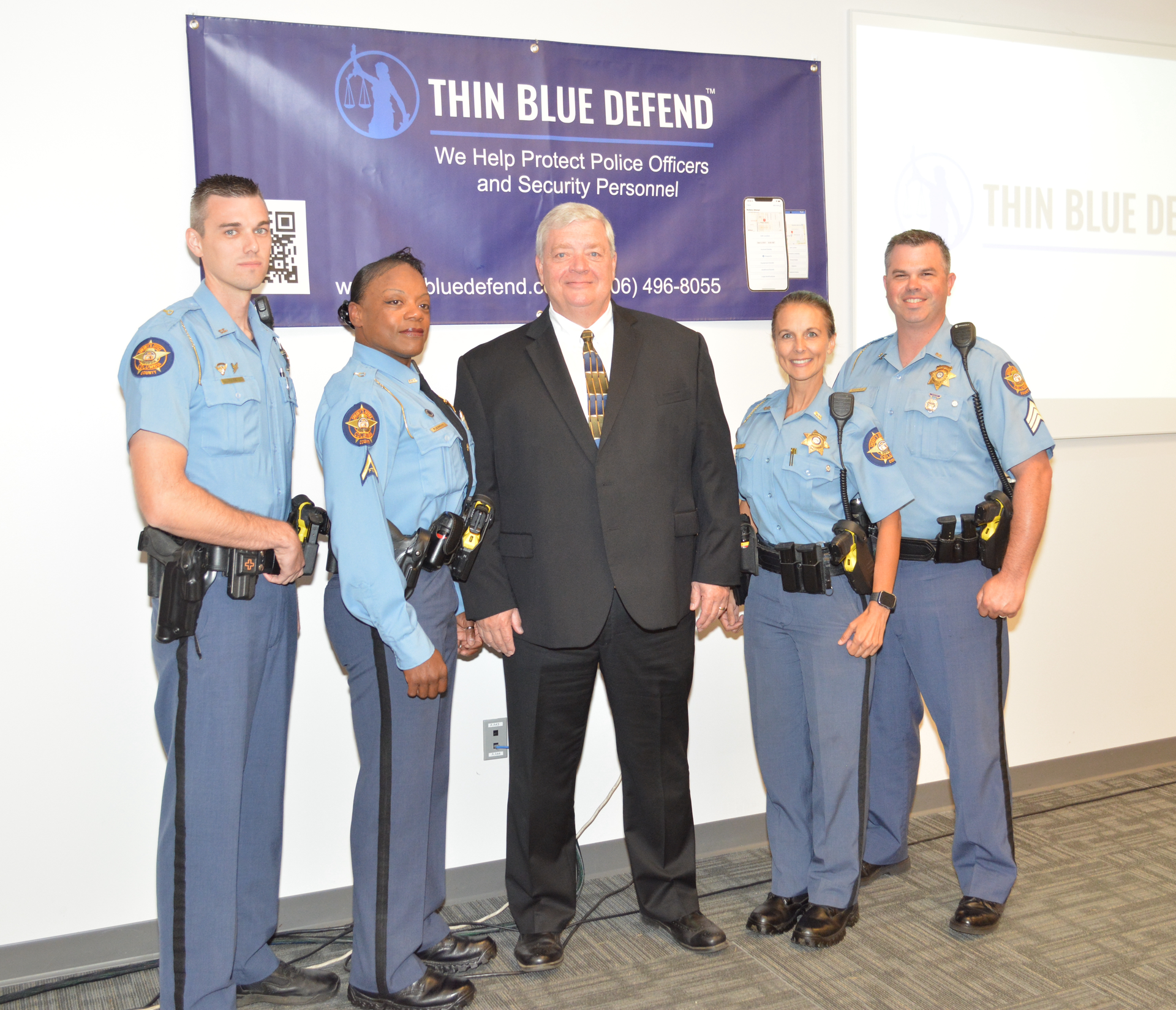 After working closely with Thin Blue Defend to help develop and test the Thin Blue Defend, Columbia County Sheriff Clay Whittle (center) with (L to R) Deputy Brandon Price, Deputy Regina Flemming, Deputy Sharon Taylor and Sergeant Josh Bogdanow discuss the benefits of the app after becoming the first in the nation to deploy it to their entire force. orce.