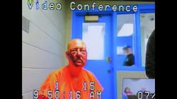 Lance Storz, accused of murdering two police officers during a stand-off in Floyd County, KY, appears by video from jail for his arraignment Friday.