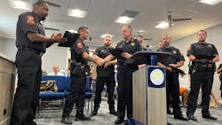 North Chicago, IL, Police Officer Gary Grayer (left) applauds Officer Donald Florance (second from left) as he is recognized by North Chicago Police Chief Lazaro Perez (center) for his response to the Highland Park July 4 parade shooting during Monday night's City Council meeting. North Chicago, IL, Police Officer Gary Grayer (left) applauds Officer Donald Florance (second from left) as he is recognized by North Chicago Police Chief Lazaro Perez (center) for his response to the Highland Park July 4 parade shooting during Monday night's City Council meeting.