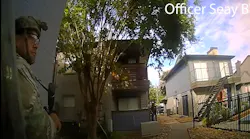 Houston police officers wait outside an apartment complex during a six-hour standoff in June with a suspect accused of shooting and wounding an officer in both legs.