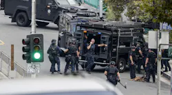 In this 2019 photo, LAPD SWAT officers stage near a Toyota Prius that authorities believe was used in the possible kidnapping of a woman in Monrovia and located in downtown Los Angeles with the suspect barricaded inside the car.