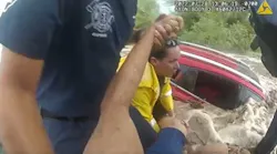 Apache Junction, AZ, police officers rescued a woman who was stranded in monsoon floodwaters last week.