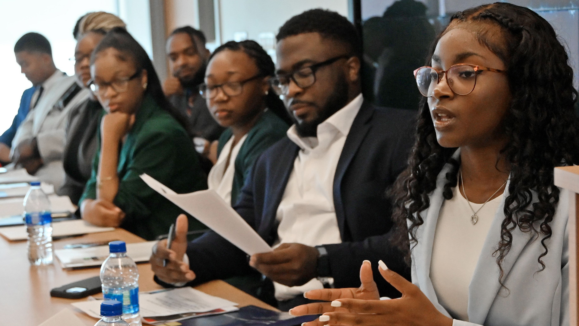 Yasmine Bryant (right), a Morgan State University junior majoring in political science, answers questions from panel members after her presentation. Bryant is among Morgan State and Coppin State University students who completed a 10-week internship with the Baltimore Police Department.