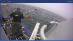 A Barnstable County, MA, sheriff&apos;s officer helps rescue a boater who fell into the water near the coast of Martha&apos; Vineyard late Monday.