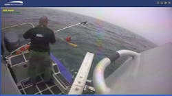A Barnstable County, MA, sheriff&apos;s officer helps rescue a boater who fell into the water near the coast of Martha&apos; Vineyard late Monday.