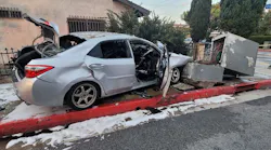 Bell Gardens, CA, police officers rescued a severely burned woman who was trapped in a car that caught fire after crashing into electrical wiring Saturday.
