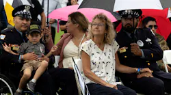 Elizabeth French sits with Chicago Police Officer Joshua Blas and Officer Carlos Yanez Jr. and his family during a memorial service Sunday marking one year since her daughter, Officer Ella French, was killed in the line of duty during a traffic stop.