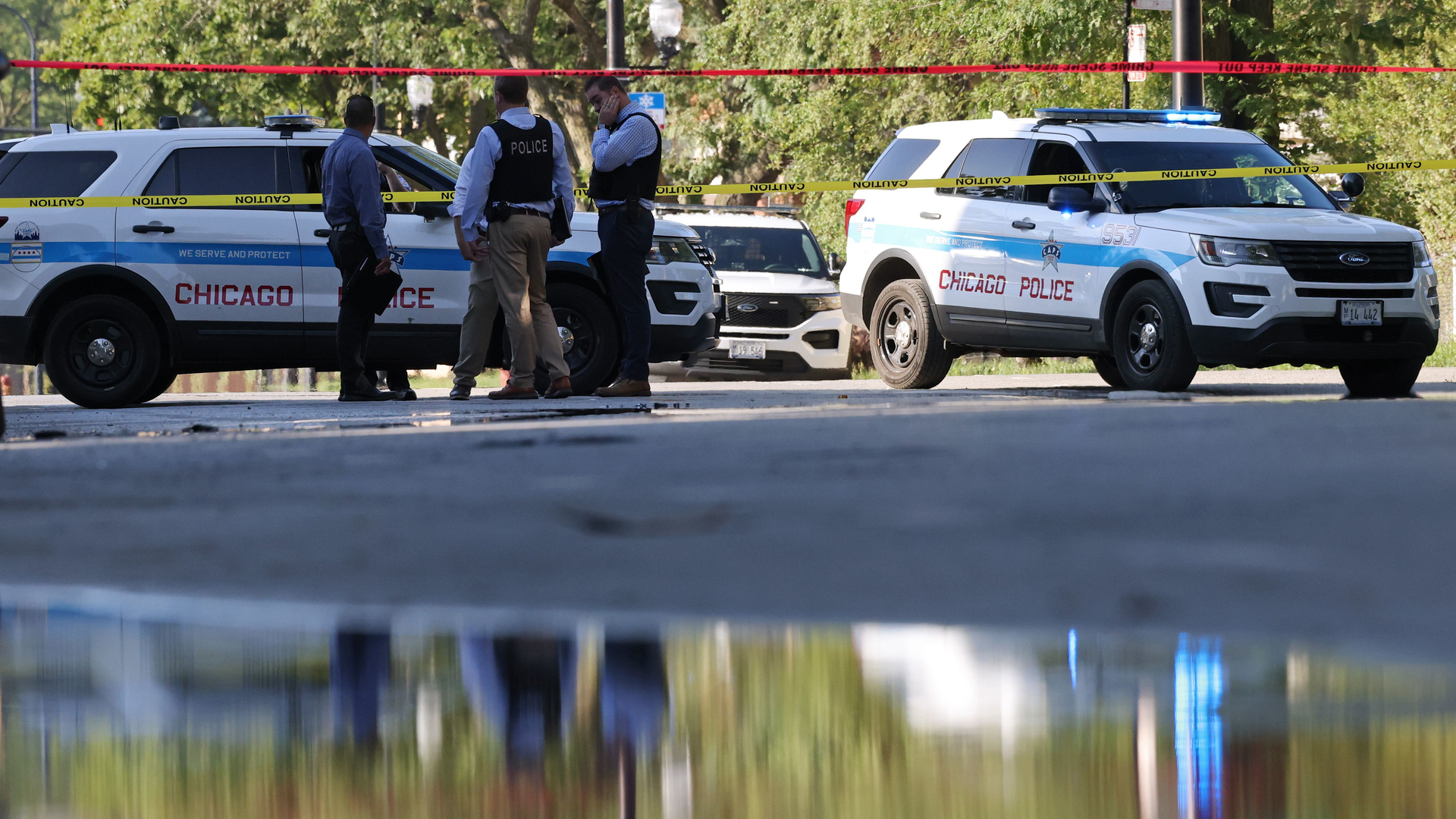 Chicago police officers investigate a shooting scene Friday.