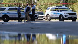 Chicago police officers investigate a shooting scene Friday. Chicago police officers investigate a shooting scene Friday.