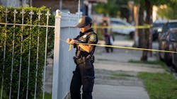 A Newark, NJ, police officer puts up caution tape on a street where a multiple shooting occurred June, 30. A Newark, NJ, police officer puts up caution tape on a street where a multiple shooting occurred June, 30.