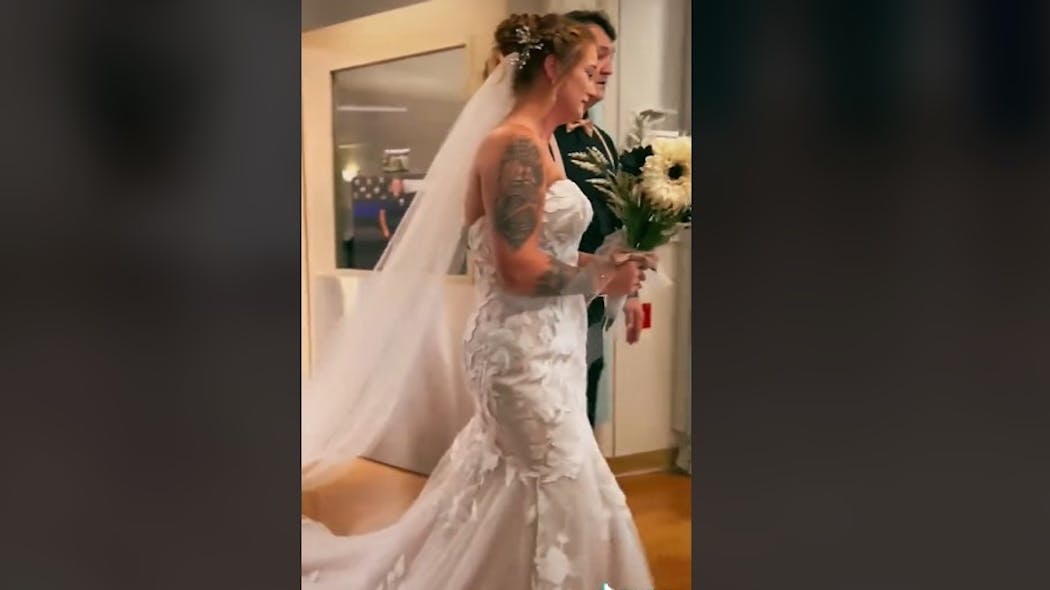 Dressed in her wedding dress, Sierra Neal prepares to unofficially marry Richmond, IN, Police Officer Seara Burton in a hospital ceremony Saturday in Dayton, OH. Burton was critically wounded in a shooting during an Aug. 10 traffic stop.