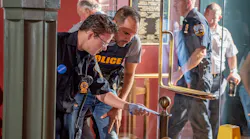 Connor Hayhurst, a teen born with a rare heart defect, works with Schenectady, NY, police officers to solve a fictional stolen artwork case at Union College on Tuesday thanks to the Make-a-Wish Foundation.