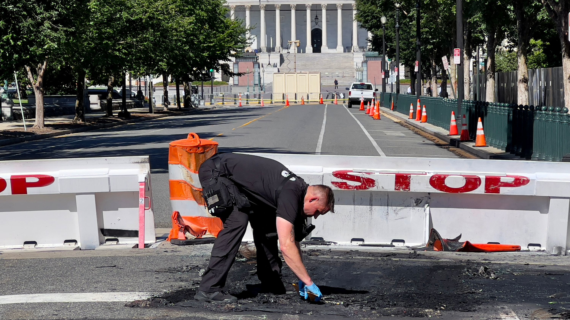 A U.S. Capitol police officer works near a barricade on Capitol Hill in Washington, D.C., on Sunday. A man died near the Capitol building after driving his car into a barricade and firing shots into the air before turning his gun on himself, police said.