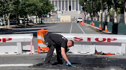 A U.S. Capitol police officer works near a barricade on Capitol Hill in Washington, D.C., on Sunday. A man died near the Capitol building after driving his car into a barricade and firing shots into the air before turning his gun on himself, police said.