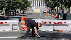 A U.S. Capitol police officer works near a barricade on Capitol Hill in Washington, D.C., on Sunday. A man died near the Capitol building after driving his car into a barricade and firing shots into the air before turning his gun on himself, police said.