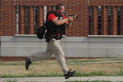 An officer carries a drawn handgun during an active shooter training session in Indianola, Iowa. An officer carries a drawn handgun during an active shooter training session in Indianola, Iowa.
