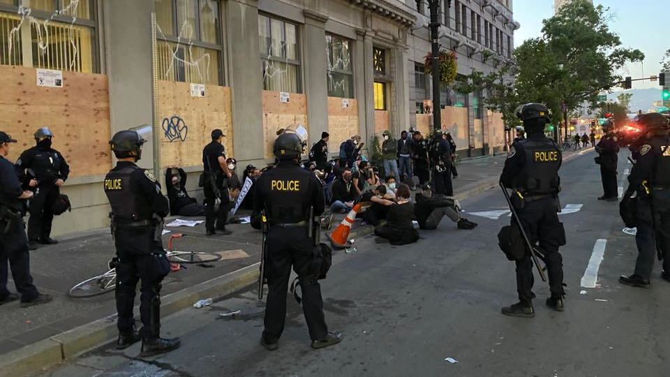 Oakland, CA, police officers detain demonstrators following a protest in June 2020.