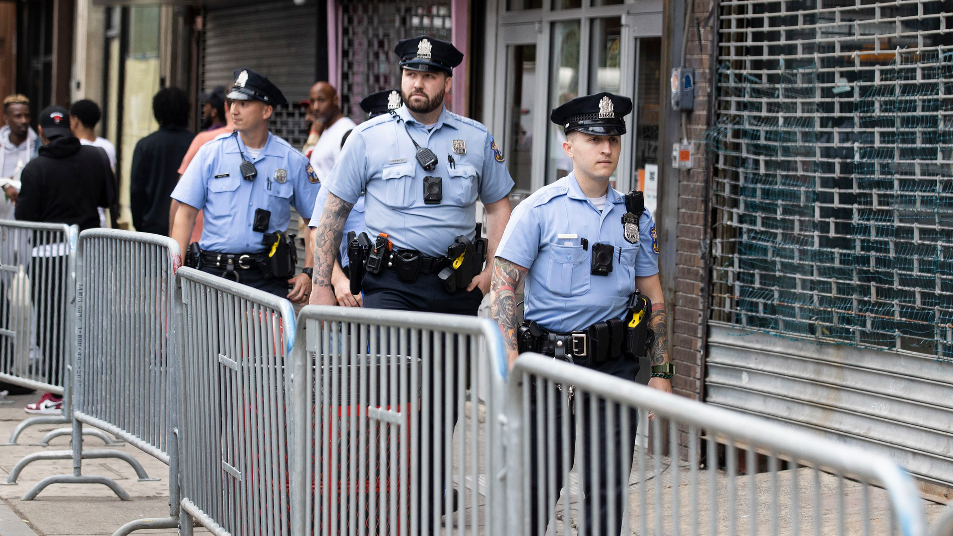Philadelphia police officers patrol South Street on June 11, a week after a mass shooting on the popular street.
