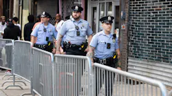Philadelphia police officers patrol South Street on June 11, a week after a mass shooting on the popular street.