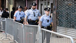 Philadelphia police officers patrol South Street on June 11, a week after a mass shooting on the popular street.