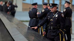 Police officers approach the south pool monument before tenth anniversary ceremonies at the site of the World Trade Center in New York City on Sept. 11, 2011.