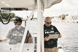 An officer with the Melbourne Police Department is seen using a TOUGHBOOK handheld while on boat patrol.