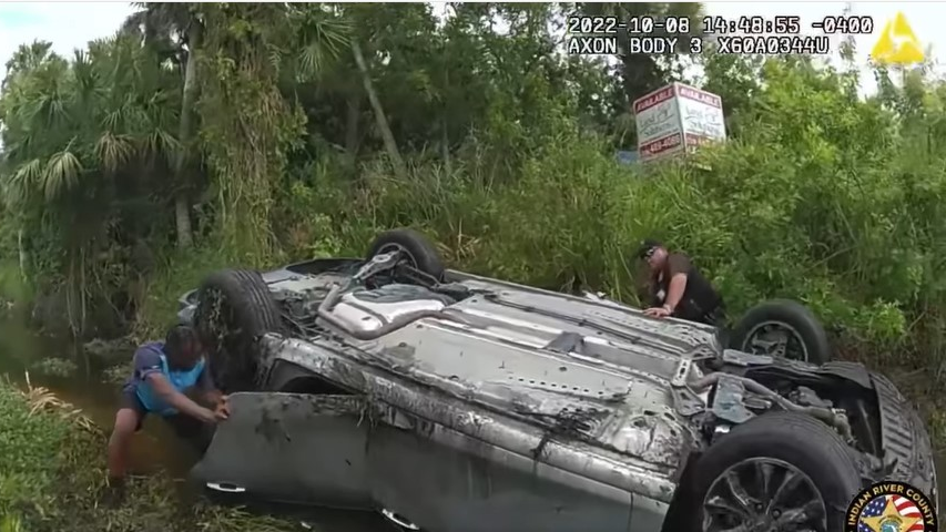 Indian River County, FL, Sheriff's Deputy Dan Whittington (right) and an Amazon driver rescued three people Oct. 8 after their car flipped over and was partially submerged in a canal.