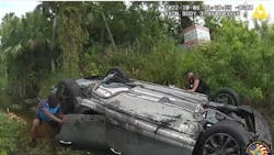 Indian River County, FL, Sheriff's Deputy Dan Whittington (right) and an Amazon driver rescued three people Oct. 8 after their car flipped over and was partially submerged in a canal. Indian River County, FL, Sheriff's Deputy Dan Whittington (right) and an Amazon driver rescued three people Oct. 8 after their car flipped over and was partially submerged in a canal.
