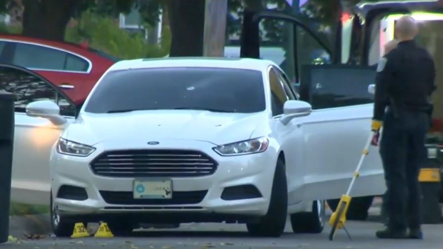 An off-duty Detroit police was injured when two suspects approached the car he was sitting in and opened fire early Monday.