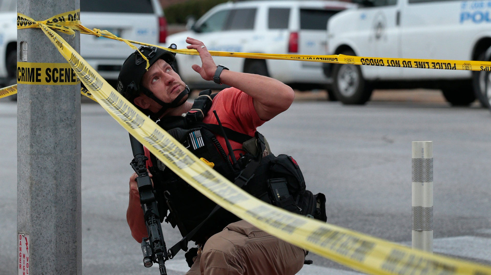 An ATF agent passes a St. Louis police SWAT vehicle at the scene of a shooting at Central Visual & Performing Arts High School and the Collegiate School of Medicine and Bioscience on Monday.