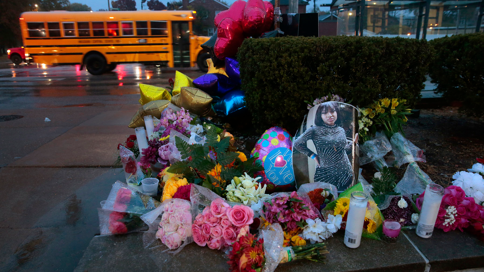 A photo of Alexandria Bell, 15, rests at the scene of a growing floral memorial to the victims of Monday's school shooting at Central Visual & Performing Arts High School. Bell and teacher Jean Kuczka were killed, along with gunman Orlando Harris.