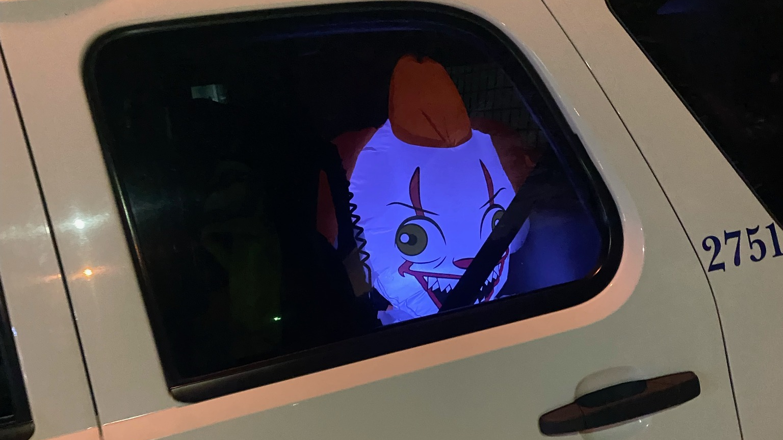 A 4-foot, illuminated, inflatable 'evil clown' stares out of the window of St. Tammany Parish, LA, Sheriff's Deputy David Arriaza's patrol unit.