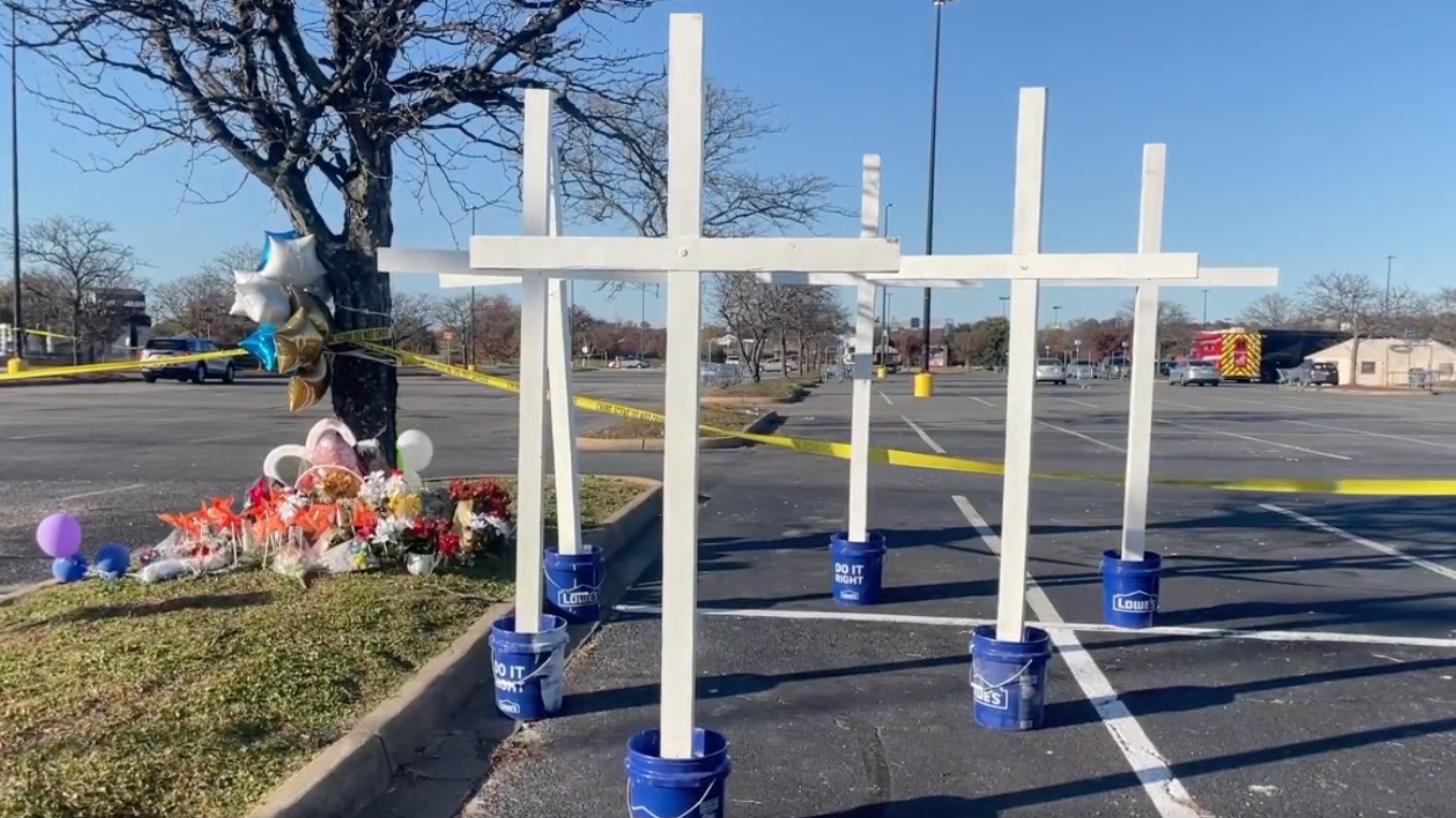 Former Chesapeake, VA, police officer Matt Cilento placed six crosses at a memorial for the victims of a Tuesday shooting at a Walmart that left seven people dead, including the shooter, a store manager.