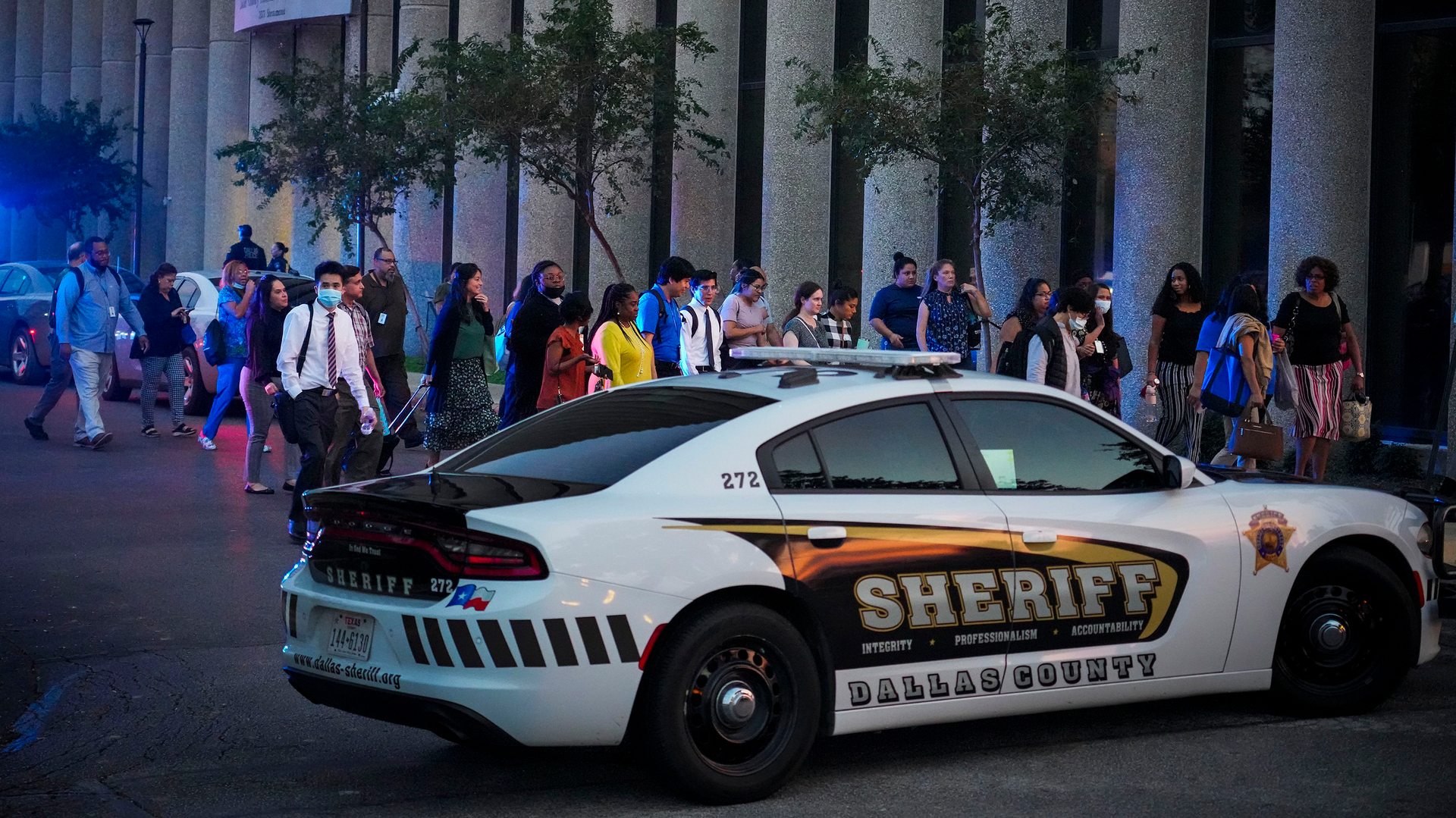 Workers evacuate the offices of Dallas County Health and Human Services head toward the parking lot as police respond to an active-shooter call at the Dallas County medical examiner&rsquo;s office Tuesday.